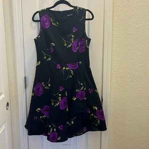 Knee length floral dress featuring purple roses. will typically fit size 8 to 10
